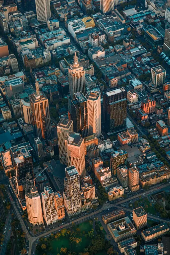 Aerial view of Melbourne CBD at golden hour, comparing city centre and inner north accommodation