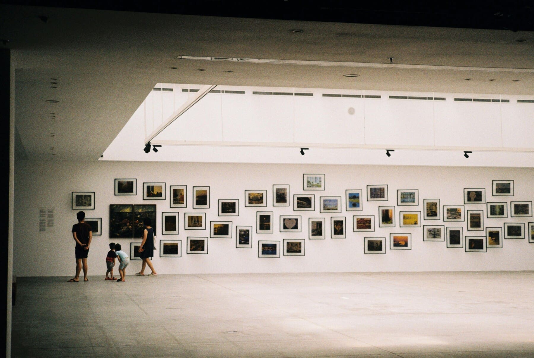 Family viewing art at a Melbourne gallery exhibition
